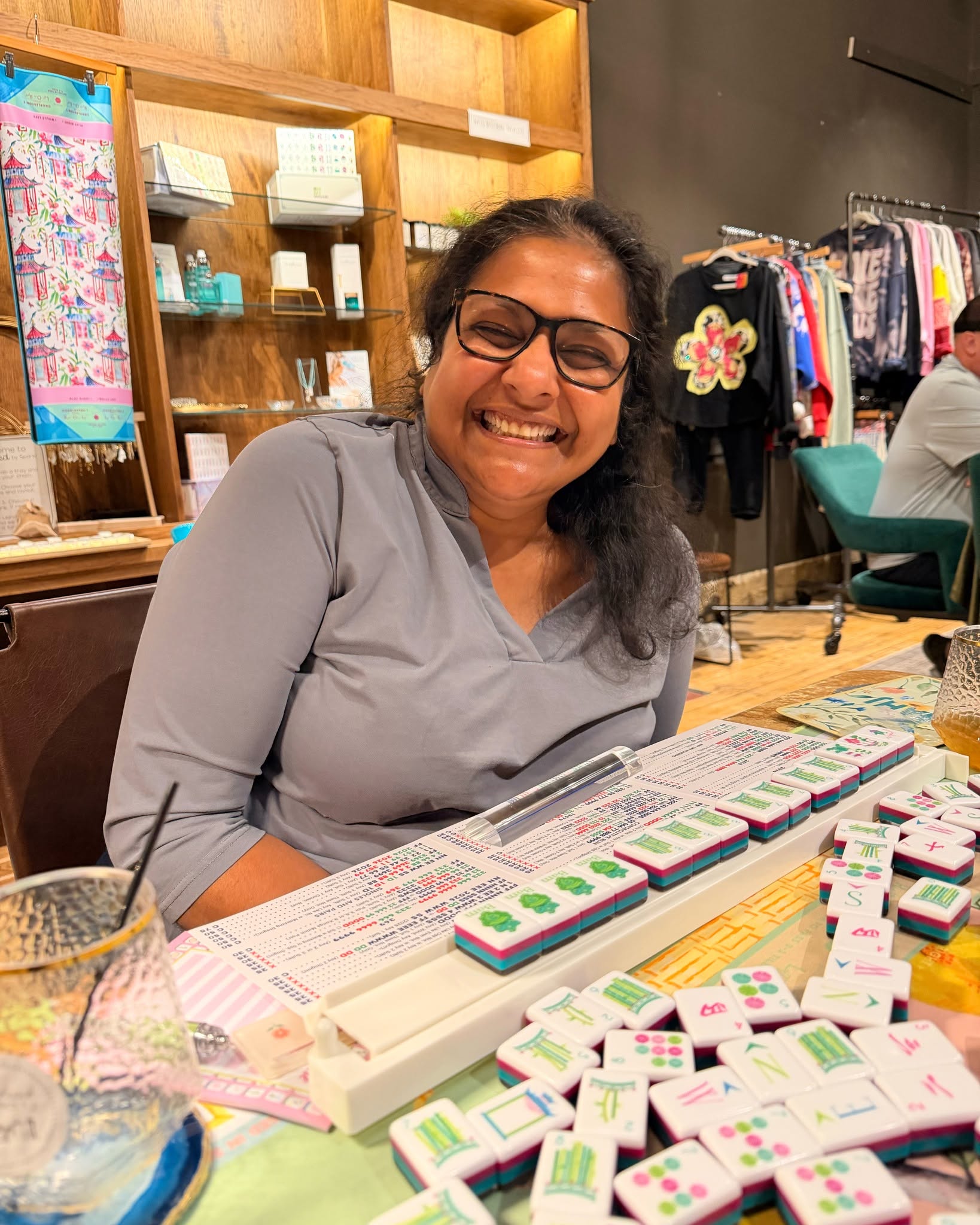 Woman playing mahjong in a store setting 