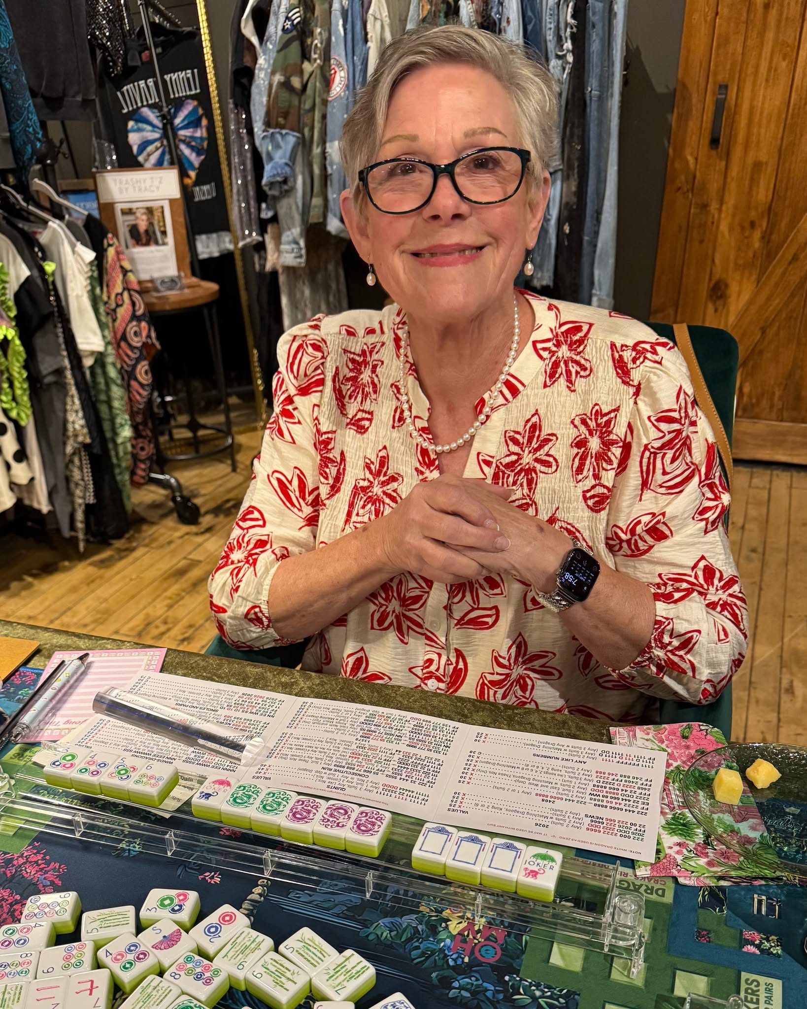 Smiling woman playing mahjong in a store setting